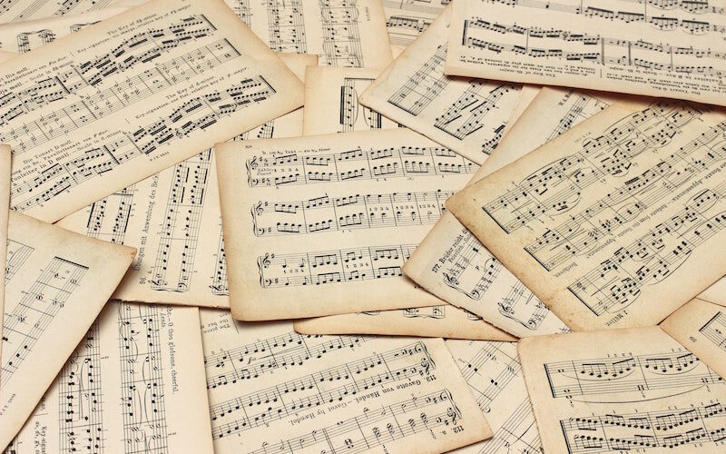A messy, disorganised pile of sheet music.